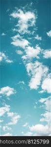 Clouds in the Blue Sky on Sunny Day, Nature Scenery with a Good Weather. Looking Up Shot. Vertical image