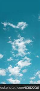 Clouds in the Blue Sky on Sunny Day, Nature Scenery with a Good Weather. Looking Up Shot. Vertical image