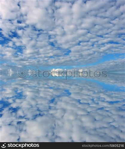 clouds in the sky with a reflection in the water