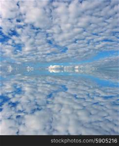 clouds in the sky with a reflection in the water