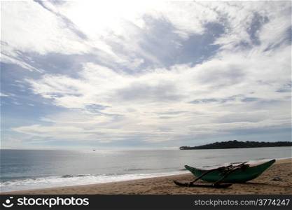 Clouds on the sky and boat on the beach in Arugam bay, Sri Lanka