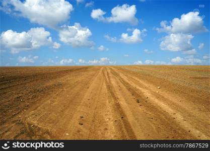 Clouds on the sky and plowed land in Israel