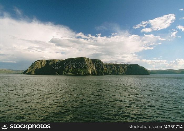 Clouds over a cliff at the waterfront, North Cape, Skarsvag, Norway