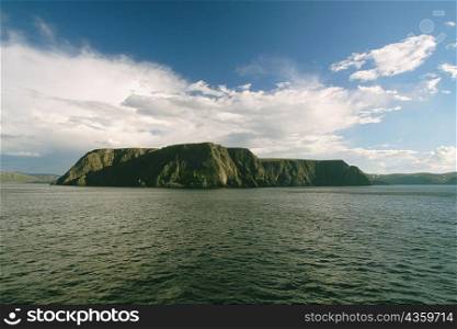 Clouds over a cliff at the waterfront, North Cape, Skarsvag, Norway
