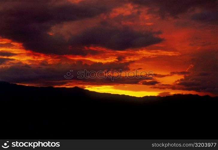 Clouds over a mountain at sunset