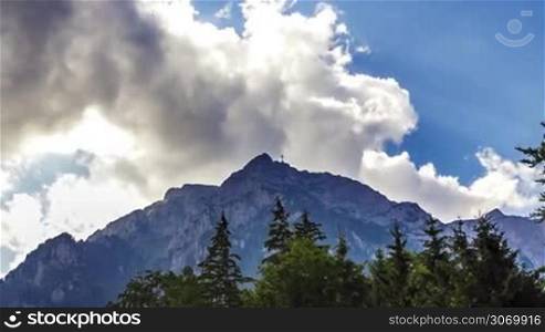 Clouds over Bucegi Mountains - time lapse. The Bucegi Mountains are located in central Romania. Big cross on Bucegi Mountains.