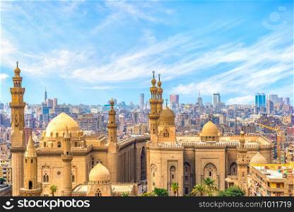 Clouds over majestic ancient Sultan Hassan Mosque in Cairo, Egypt. Clouds over Sultan Hassan Mosque
