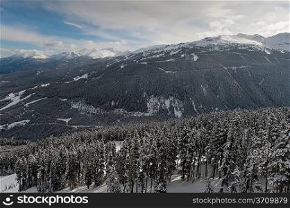 Clouds over snow covered mountains, British Columbia, Canada