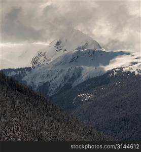 Clouds over snow covered mountains, Whistler, British Columbia, Canada