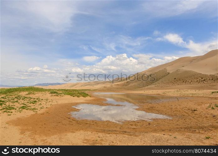 Clouds over the Gobi desert, dune Hongoryn, Mongolia.