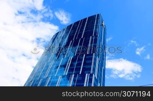clouds reflected in the glass walls of skyscrapers