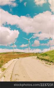 clouds road wind turbines