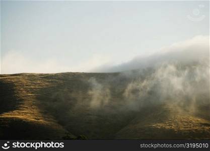 Clouds rolling over a hill range