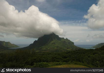 Clouds seeming to touch the top of hills near the ocean, Moorea, Tahiti, French Polynesia, South Pacific