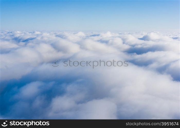 Clouds. view from the window of an airplane. cloudscape scenery with blue sky above