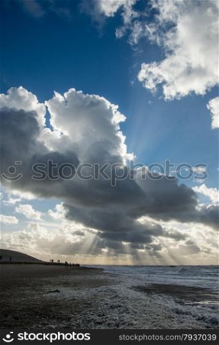 cloudscape above the dutch sea with sunbeams