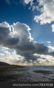 cloudscape above the dutch sea with sunbeams