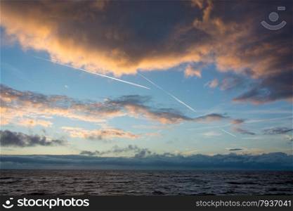 cloudscape and contrails above the dutch sea