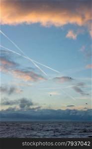 cloudscape and contrails above the dutch sea