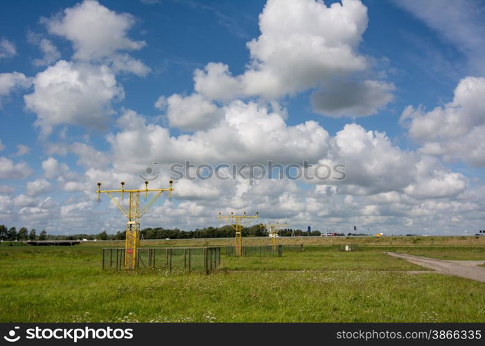 cloudscape at airport between the runway lights