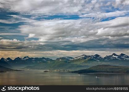 Cloudscape over the mountains in Molde with some boats in the fjord, Norway. Cloudscape over the mountains in Molde, Norway