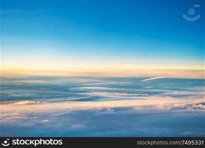 Cloudscape with clear blue sky and fluffy clouds, view from above