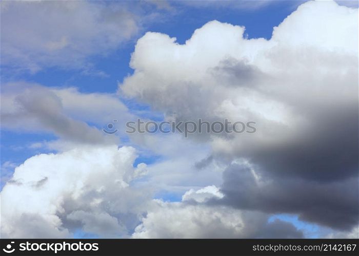 Cloudscape with fluffy cirrus and some blue sky with possible storm