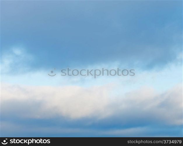 cloudscape with with gray winter clouds in blue afternoon sky