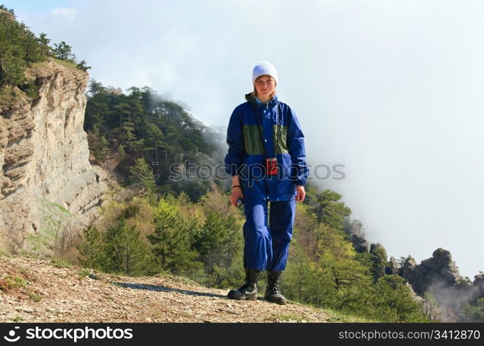 Cloudy Aj-Petri Mountain top view (Crimea, Ukraine) and tourist on slope