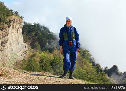 Cloudy Aj-Petri Mountain top view (Crimea, Ukraine) and tourist on slope