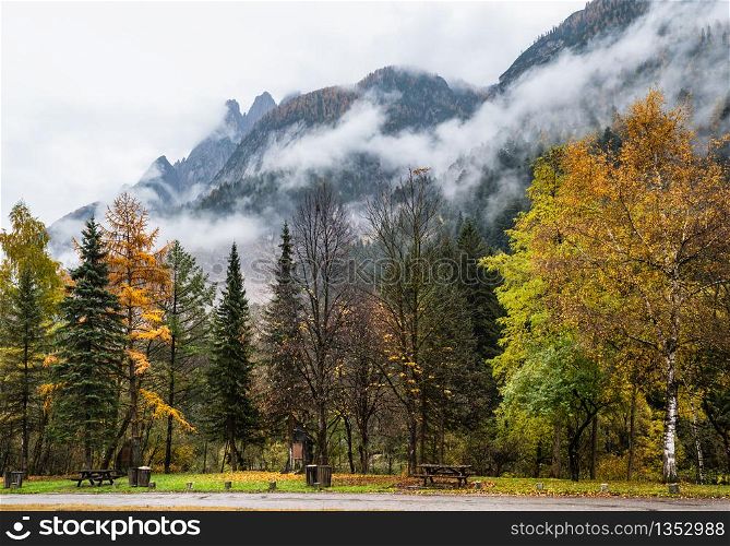 Cloudy and foggy autumn alpine mountain scene. Austrian Lienzer Dolomiten Alps. Peaceful picturesque traveling, seasonal, nature and countryside beauty concept scene.