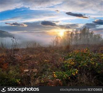 Cloudy and foggy autumn mountain sunrise scene. Peaceful picturesque traveling, seasonal, nature and countryside beauty concept scene.