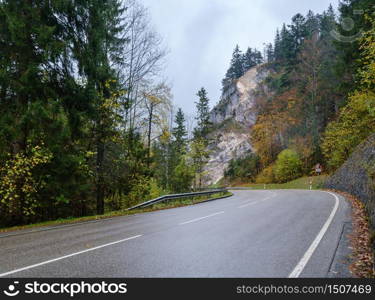 Cloudy and foggy autumn pre alps mountain view from German Alpine road or Alpenstrasse. Peaceful picturesque traveling, seasonal, nature beauty concept scene.