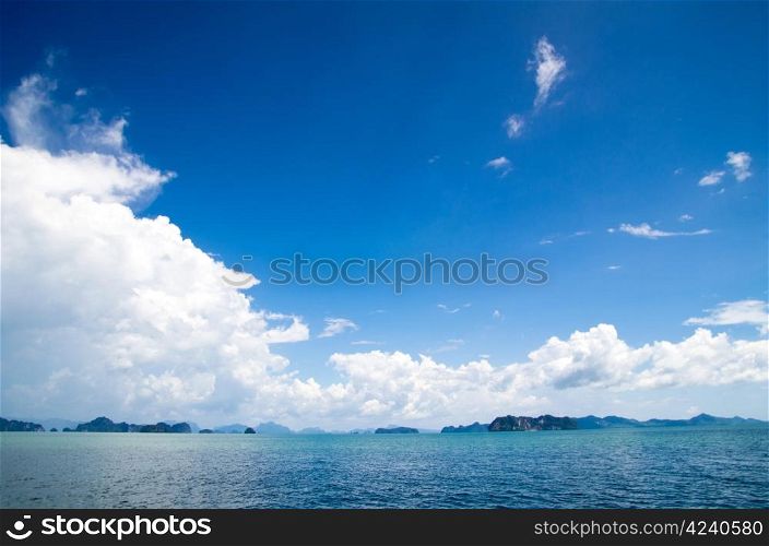 cloudy blue sky above a surface of the sea