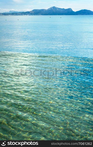 cloudy blue sky leaving for horizon above a blue surface of the sea. sky leaving for horizon above a blue surface of the sea