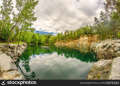 cloudy skies and reflections at a quarry