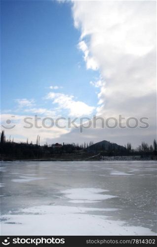 Cloudy skies over the deserted winter lake