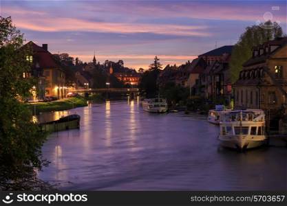 Cloudy sky at sunset, Regnitz river with ships in Bamberg, Germany&#xA;