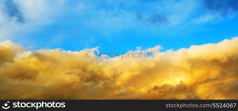 Cloudy sky in the colors of the Ukrainian state flag. Blue sky and bright yellow clouds.