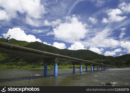 cloudy sky over bridge