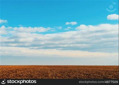 Cloudy Sky Over Harvested Land In Autumn