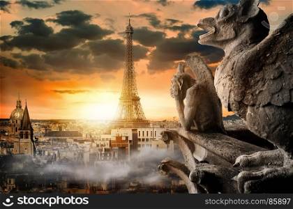 Cloudy sky over Notre Dame chimeras and parisian cityscape, France
