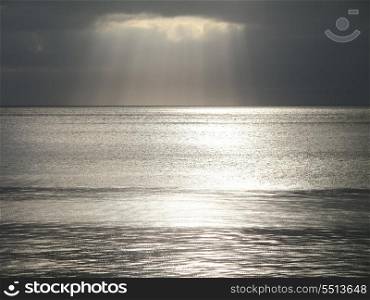 Cloudy sky with rays of light over the sea