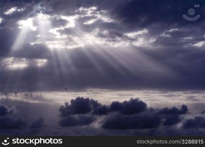 Cloudy stormy sky with sun ray breaking through