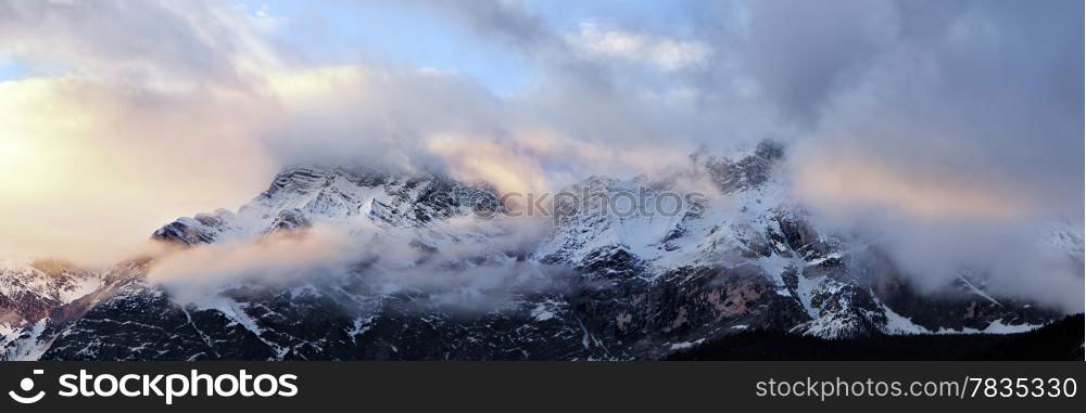 Cloudy sunrise over Dolomites mountains. Italian Dolomites