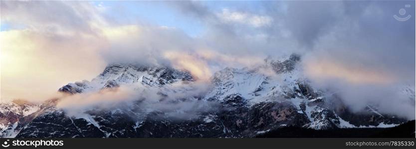 Cloudy sunrise over Dolomites mountains. Italian Dolomites