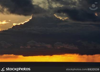 Cloudy sunset sky and sea horizon. Abstract nature background.
