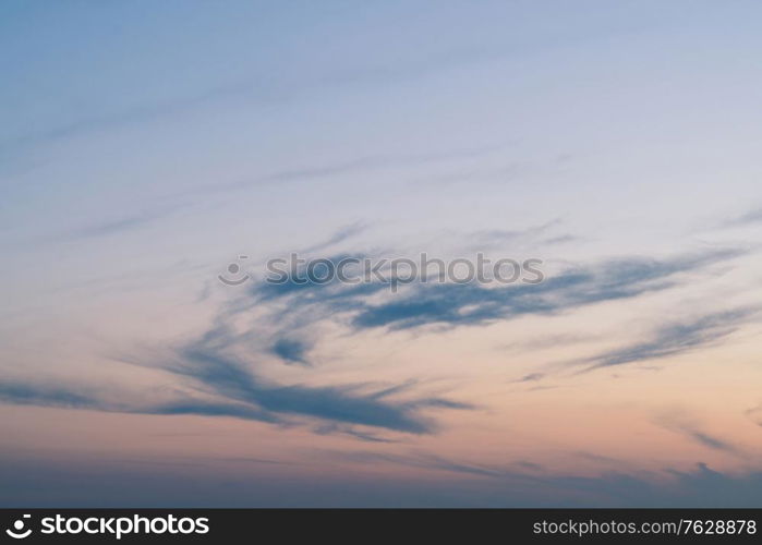 Cloudy sunset with clouds in the wind in cold blue colors