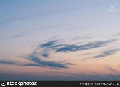 Cloudy sunset with clouds in the wind in cold blue colors