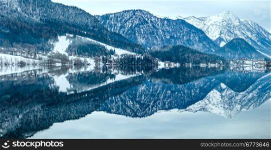 Cloudy winter Alpine lake Grundlsee panorama (Austria) with fantastic pattern-reflection on the water surface.
